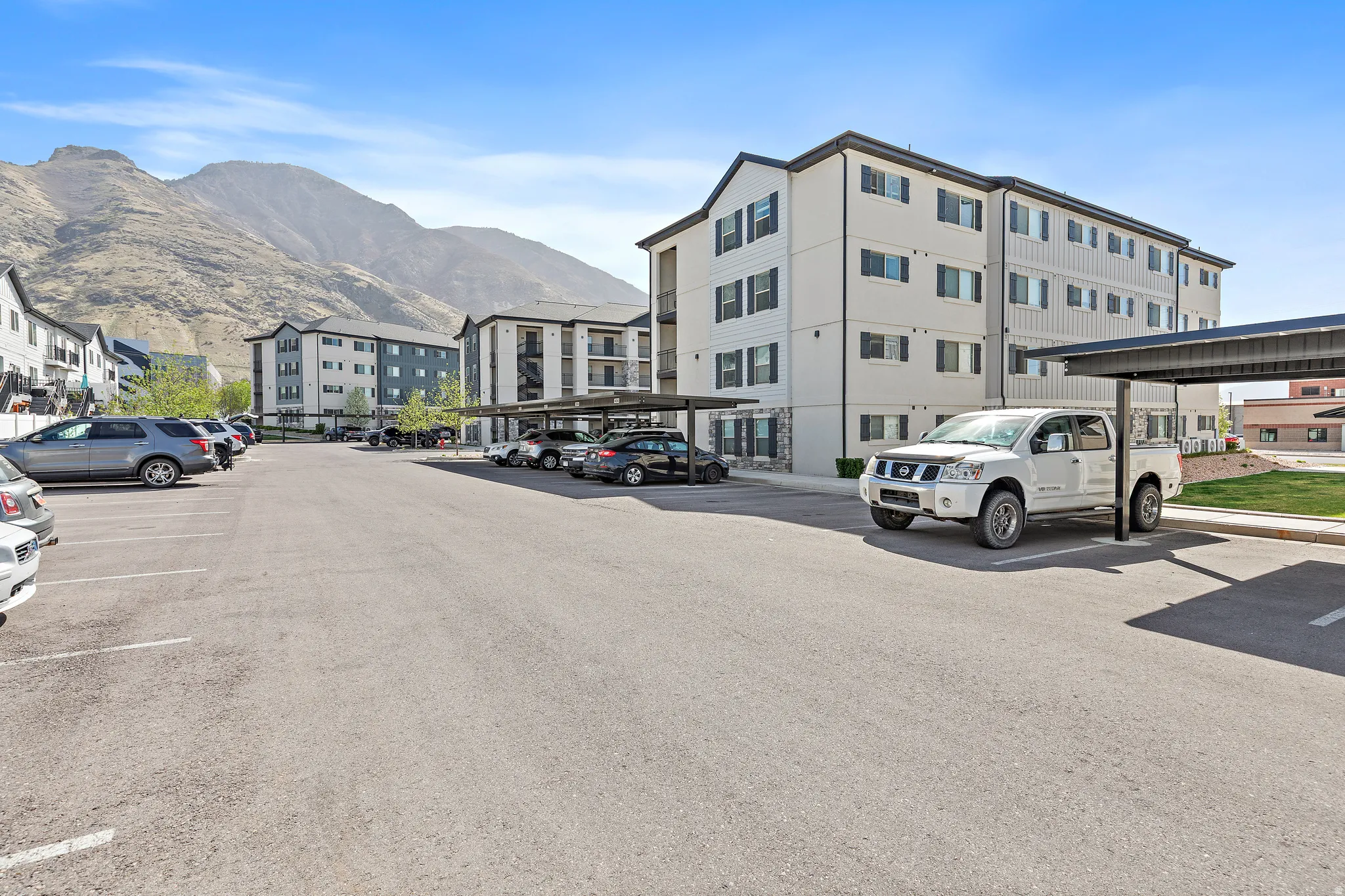 Partially covered parking lot featuring a mountain view