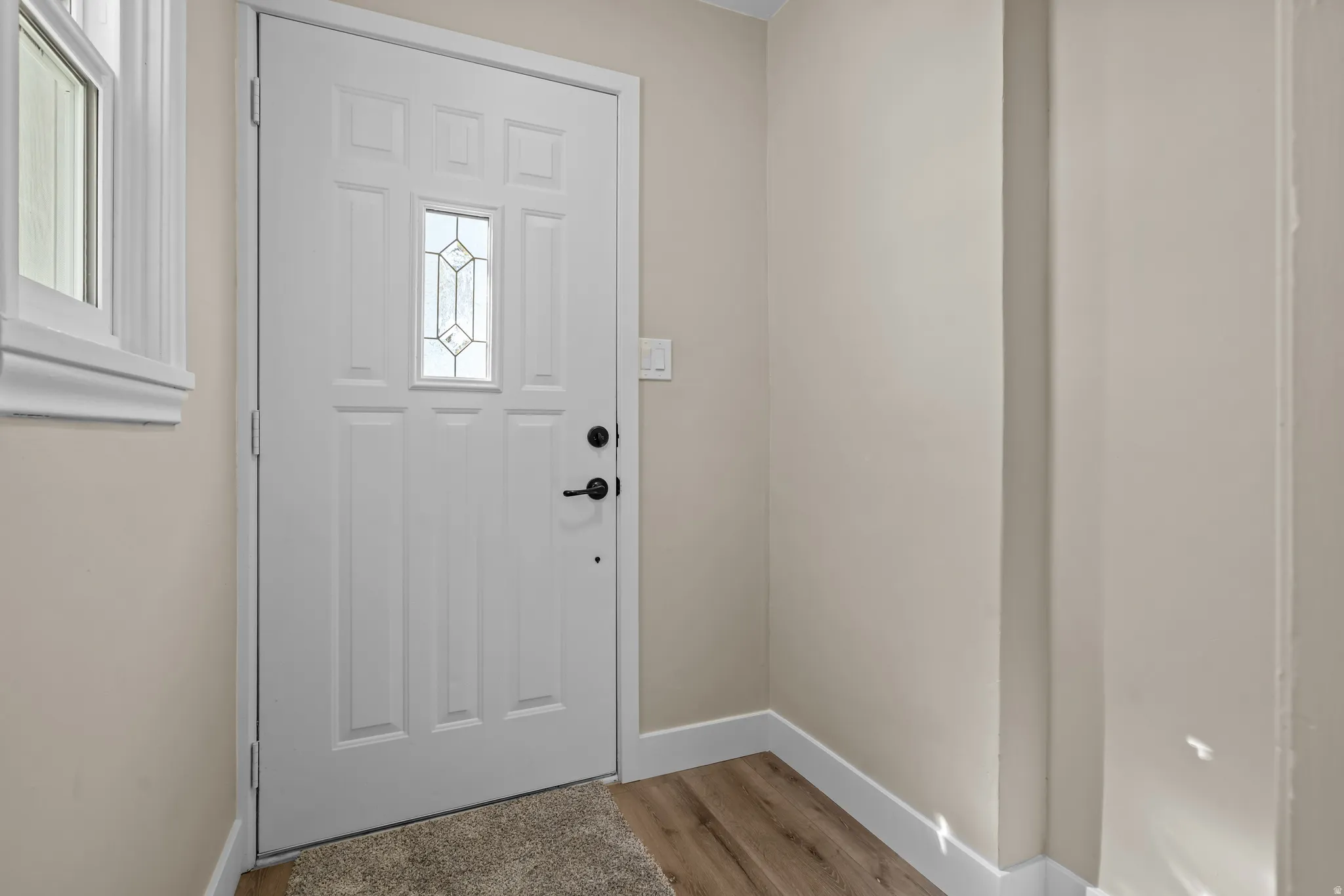 Entrance foyer featuring light wood-type flooring and baseboards