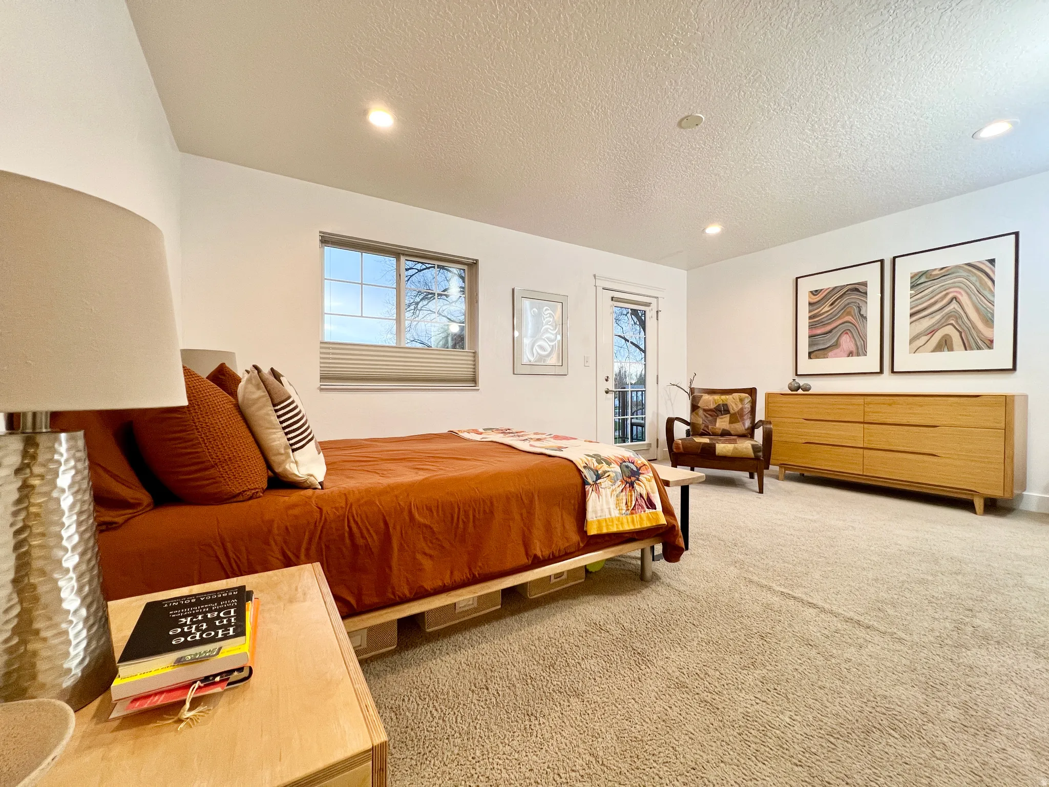 Bedroom featuring access to exterior, a textured ceiling, light carpet, and recessed lighting