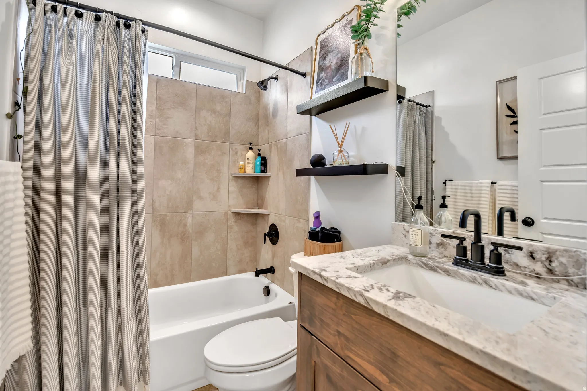 Full bath with vanity and shower / bath combination with curtain