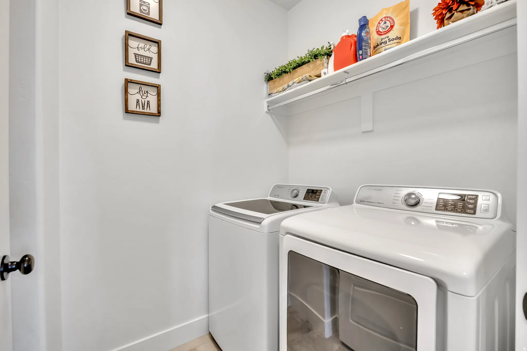 Laundry room with washer and dryer and baseboards