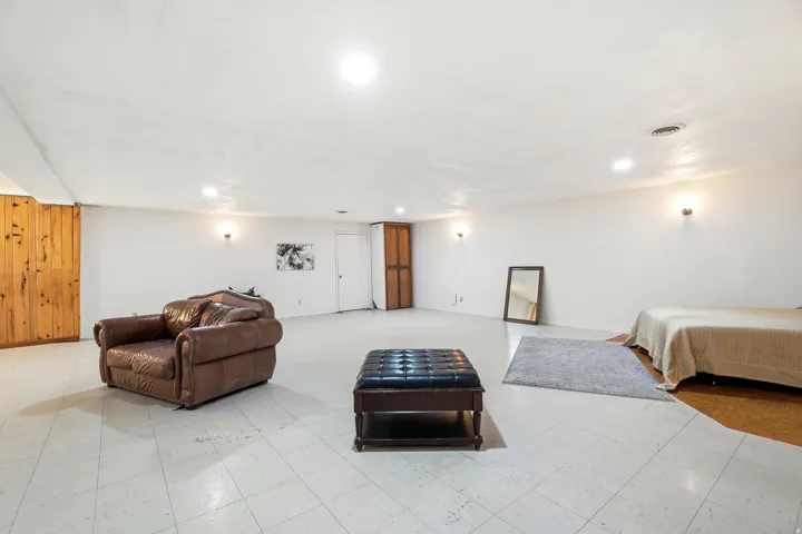 Bedroom with light floors and recessed lighting