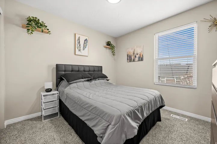 Bedroom with light colored carpet
