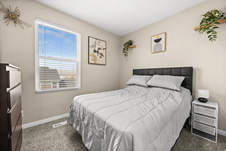 Bedroom featuring dark carpet and baseboards