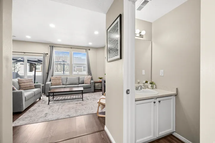 Bathroom featuring dark wood-style flooring, vanity, and recessed lighting