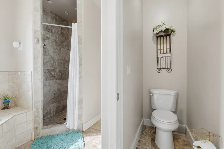 Full bathroom featuring a stall shower and a garden tub