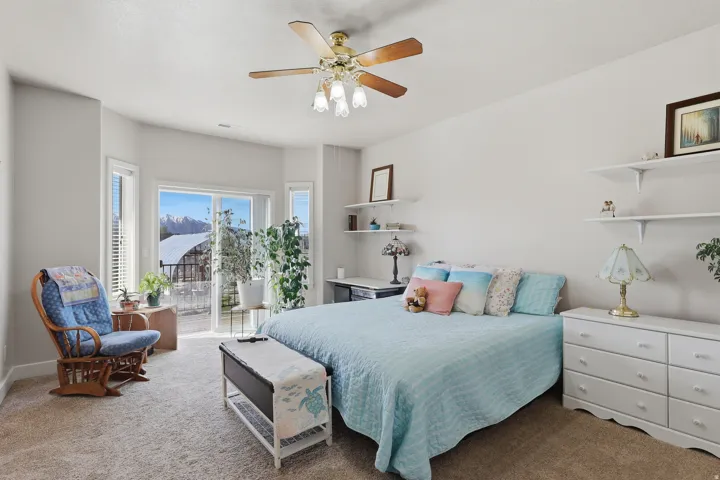 Bedroom featuring carpet, access to outside, and a ceiling fan