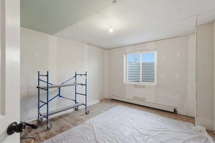 Spare room featuring a baseboard heating unit and light wood-style floors