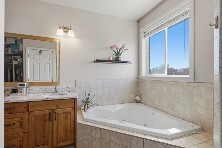 Bathroom featuring vanity and a jetted tub