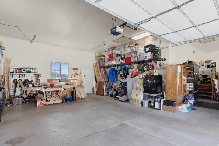 Garage featuring a workshop area and a garage door opener