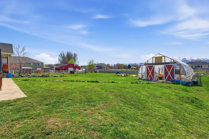 View of yard with an outdoor structure and a residential view