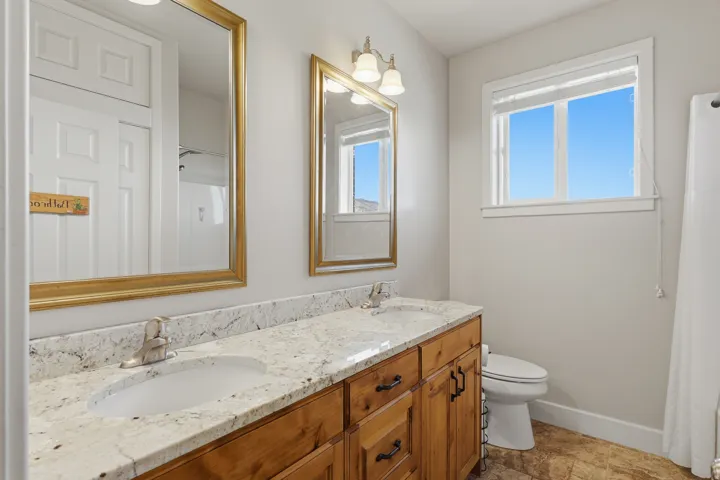 Bathroom featuring double vanity and a shower with curtain