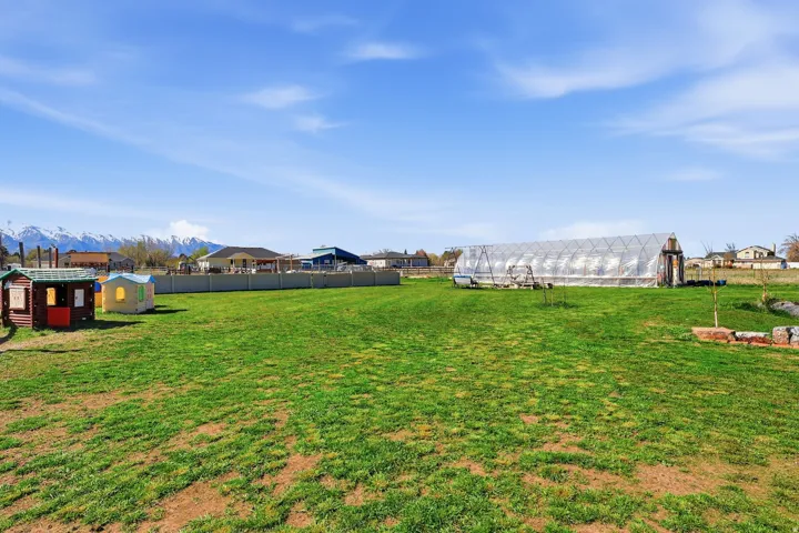 View of yard with an outdoor structure, an exterior structure, a mountain view, and a residential view
