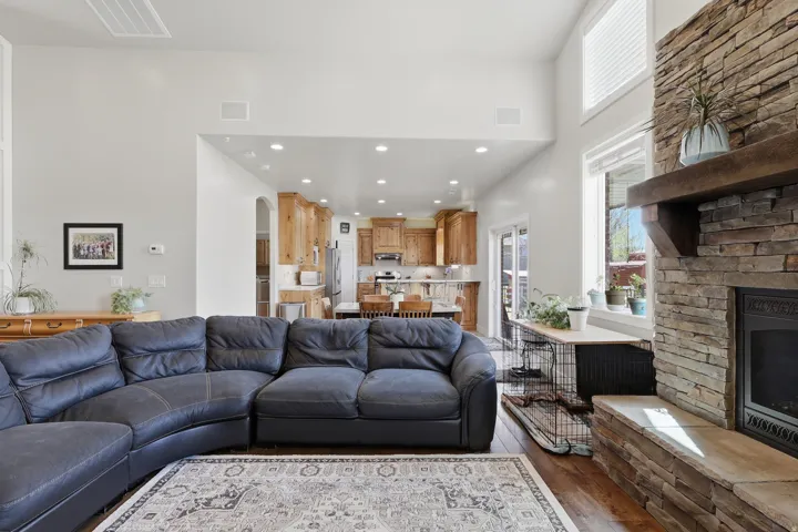 Living room featuring recessed lighting, dark wood-style flooring, a fireplace, and arched walkways