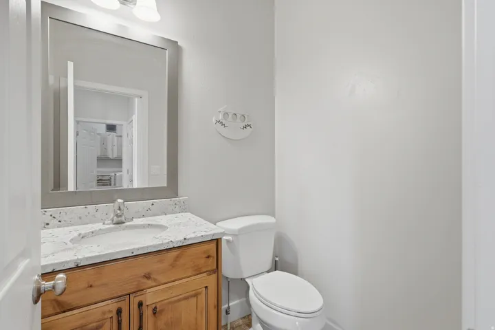 Half bathroom with vanity and toilet