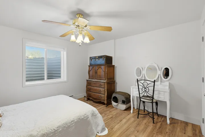 Bedroom featuring a ceiling fan and light wood finished floors