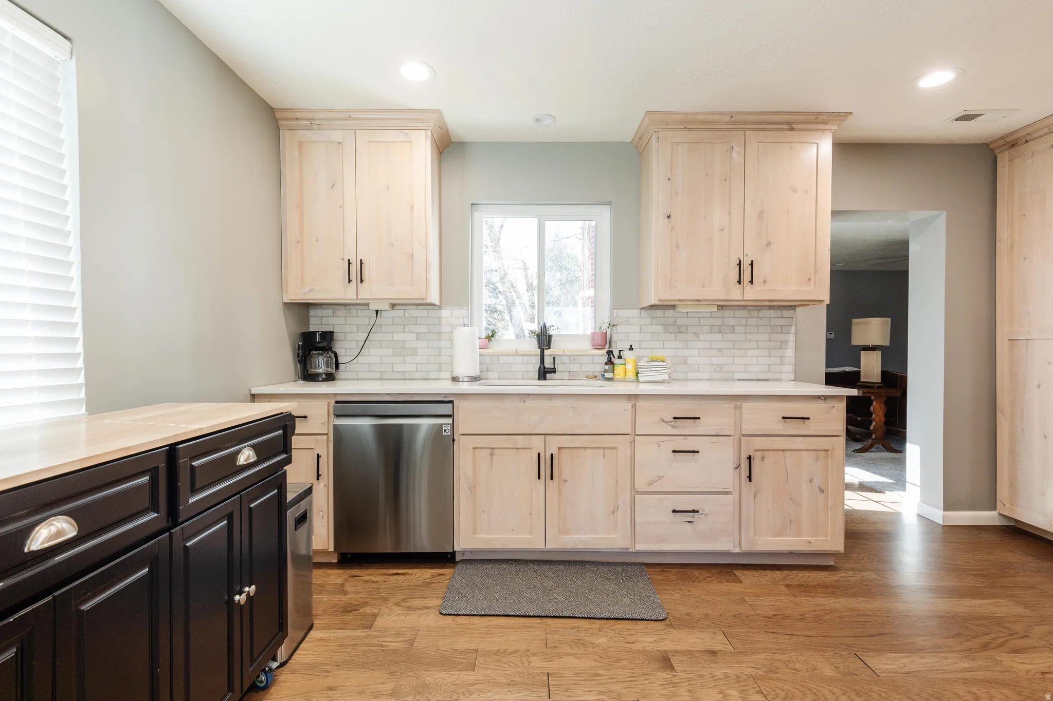 Kitchen featuring stainless steel appliances, light wood-style cabinets, light stone counters, and recessed lighting