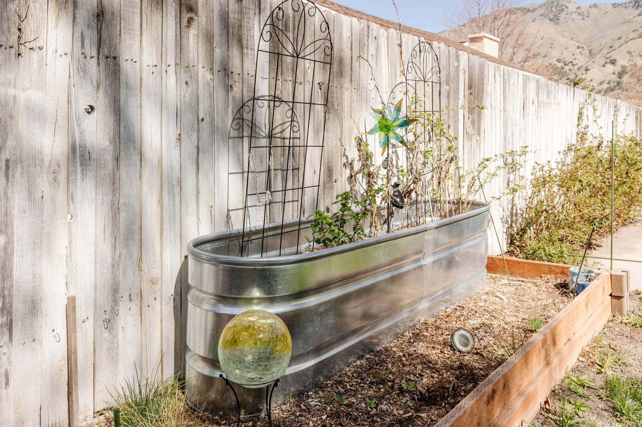 Fenced backyard featuring a patio, and a garden