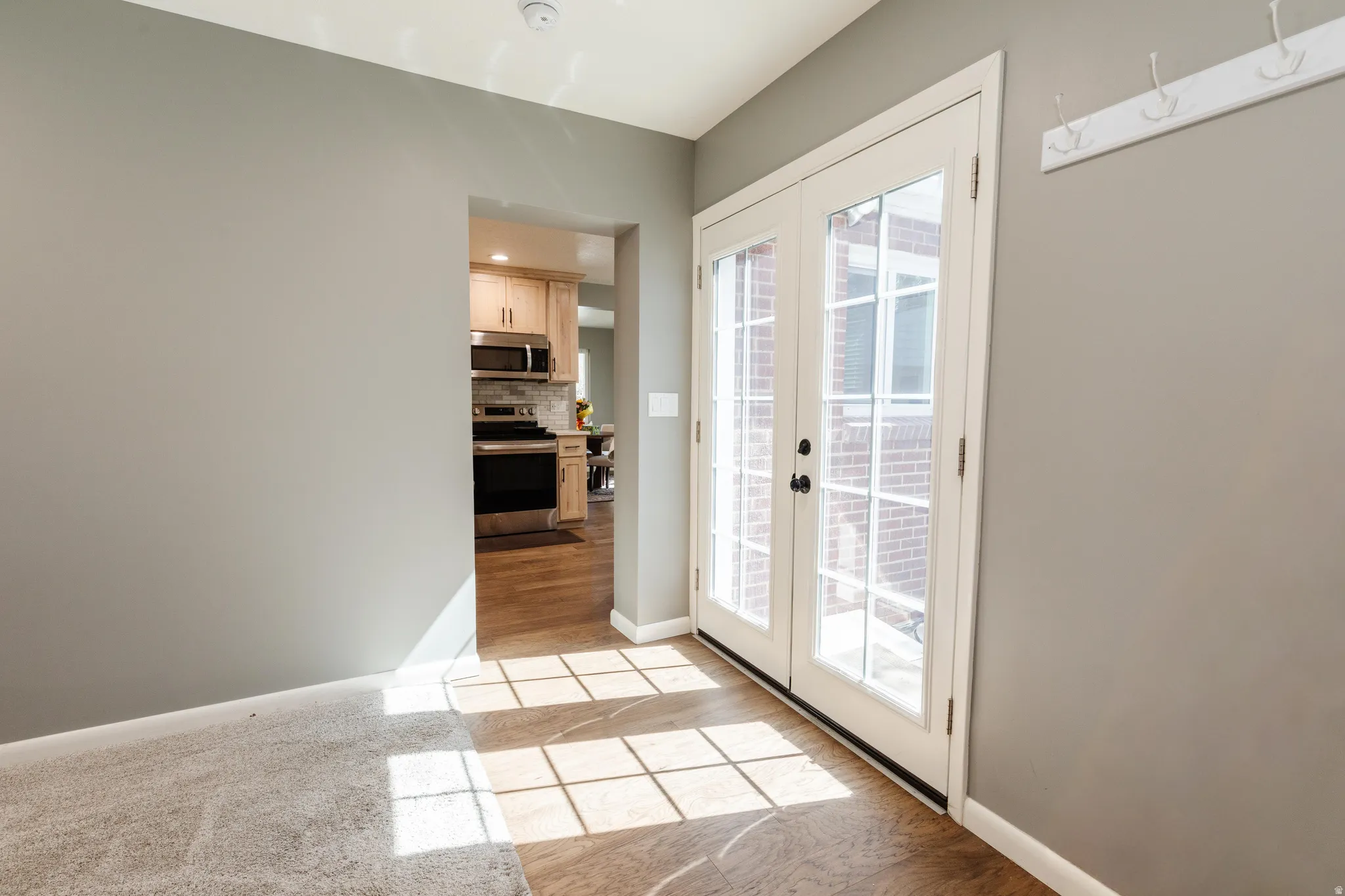 Doorway with french doors to the backyard off the living room