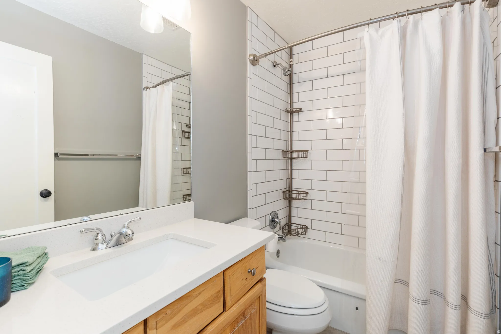 Bathroom with vanity and shower / tub combo with curtain