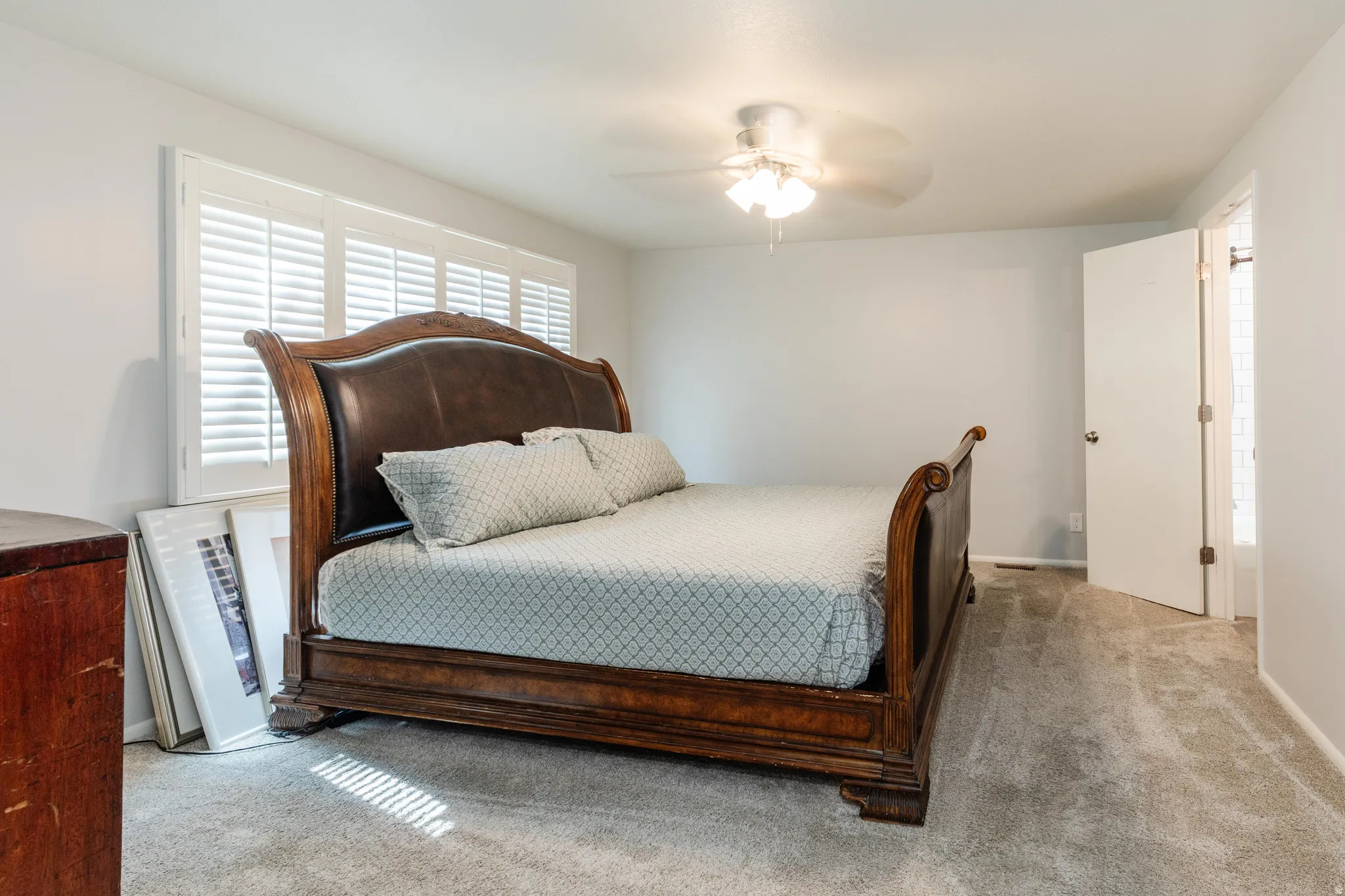 Main Bedroom with light colored carpet and a ceiling fan