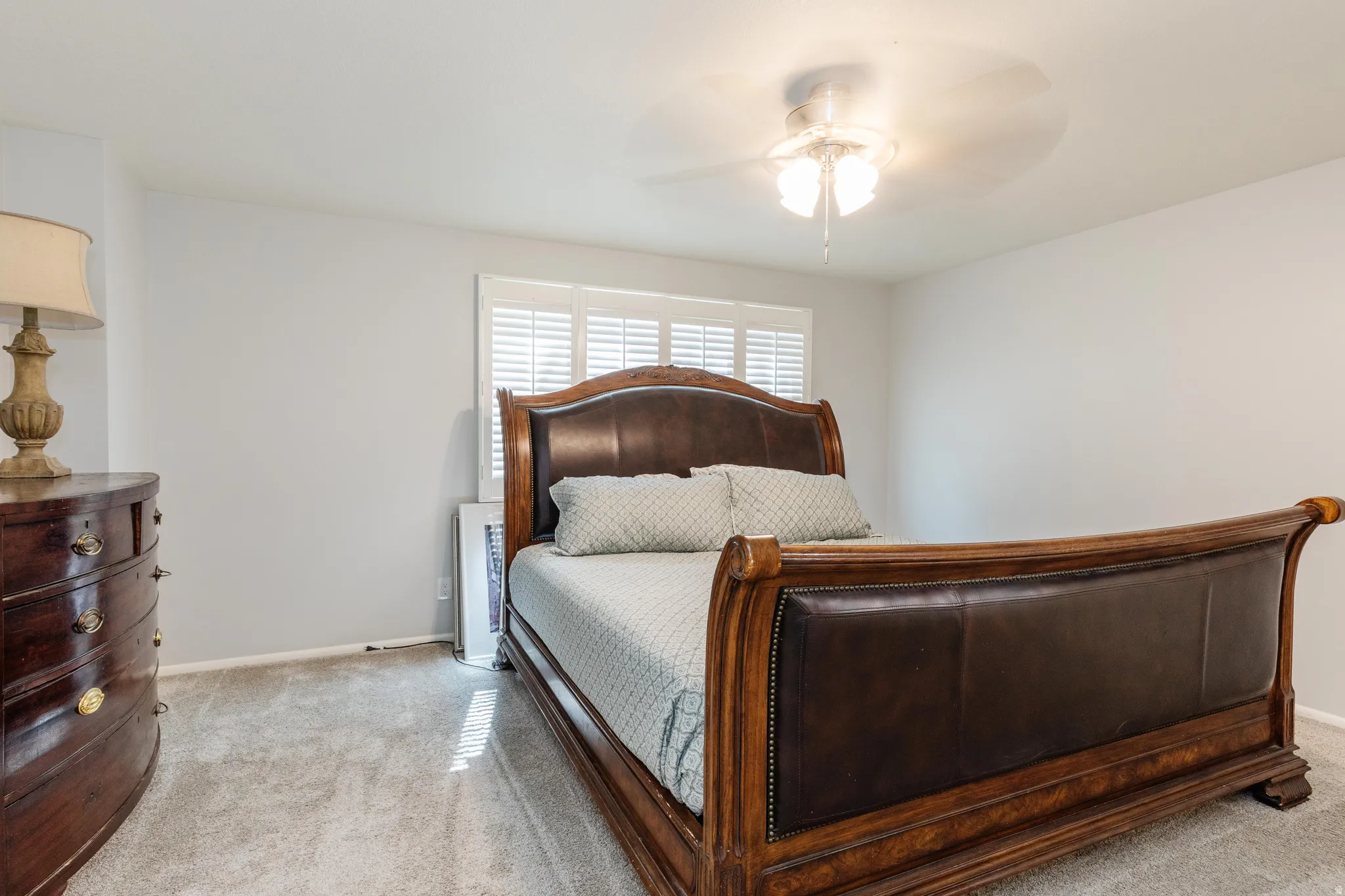Main Bedroom with light carpet and a ceiling fan