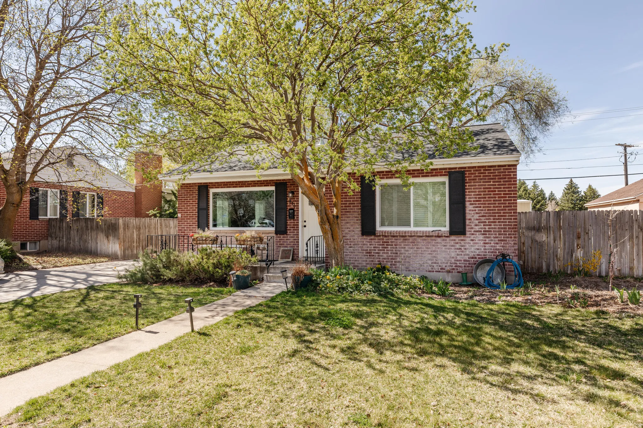 Bungalow-style house featuring brick siding and roof with shingles