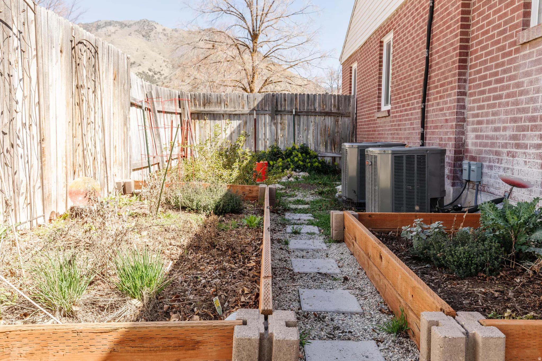 Fenced backyard with a garden
