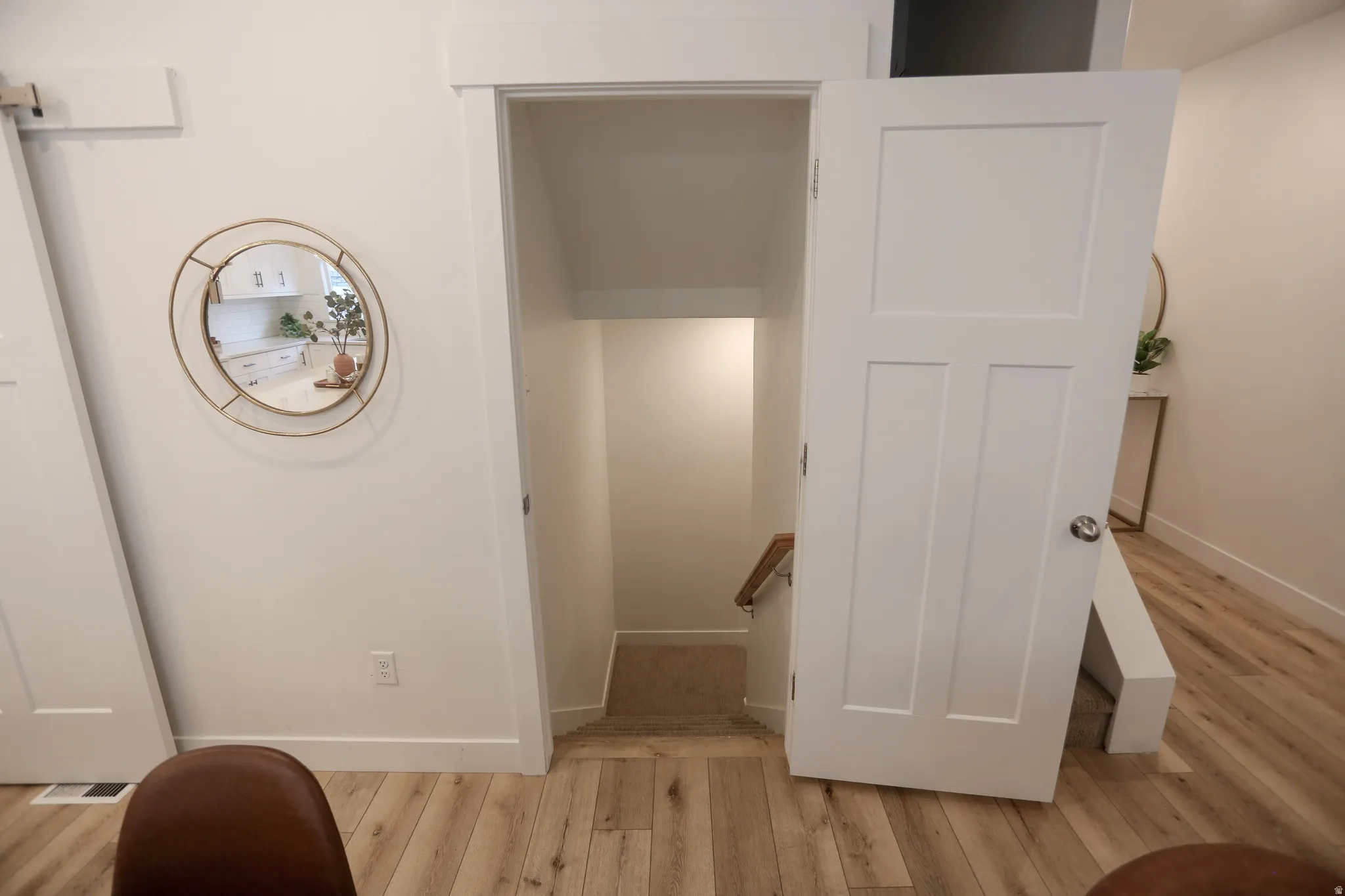 Staircase with wood finished floors and baseboards