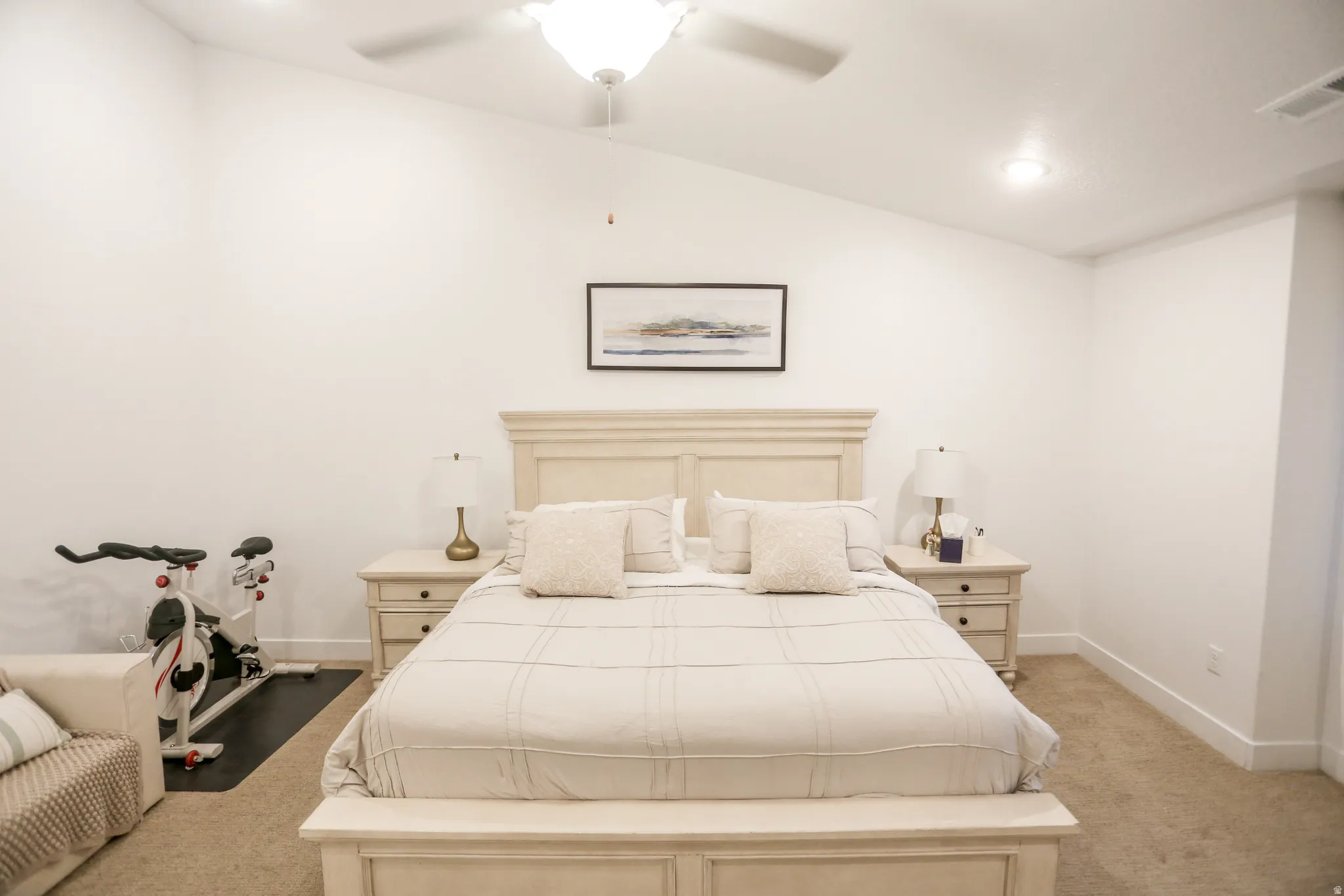 Bedroom featuring light carpet, a ceiling fan, and lofted ceiling