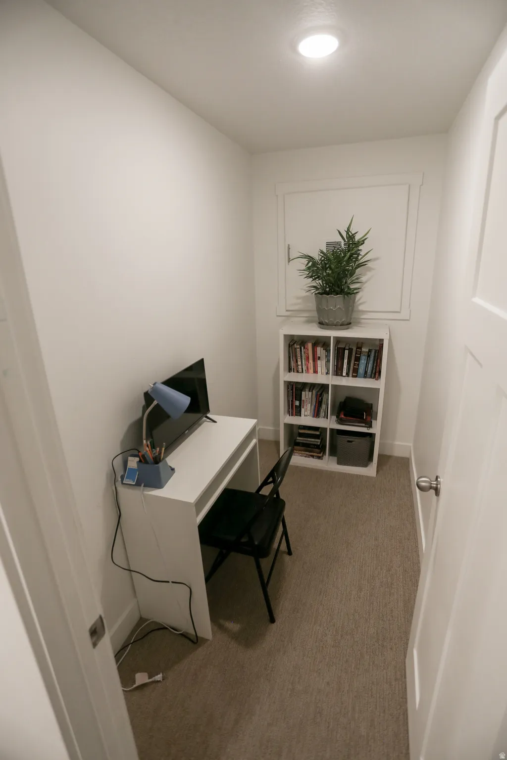Office area with light carpet and baseboards
