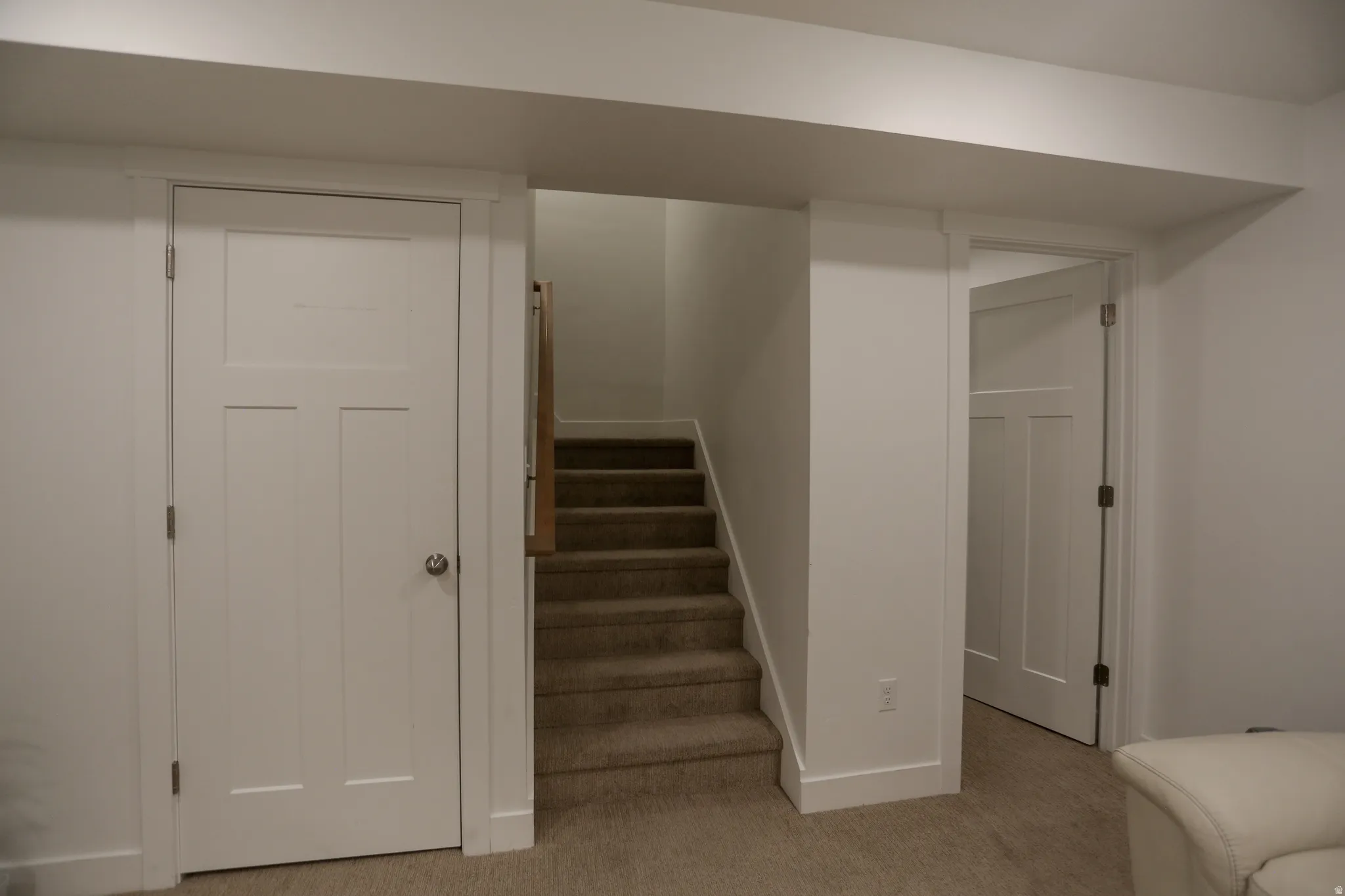 Staircase with carpet floors and baseboards