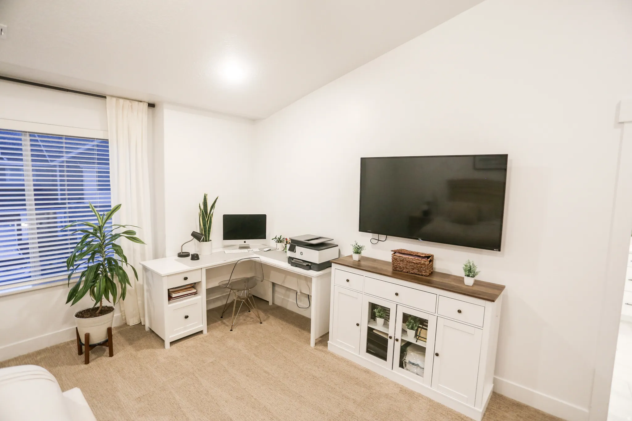 Office space featuring light colored carpet and baseboards