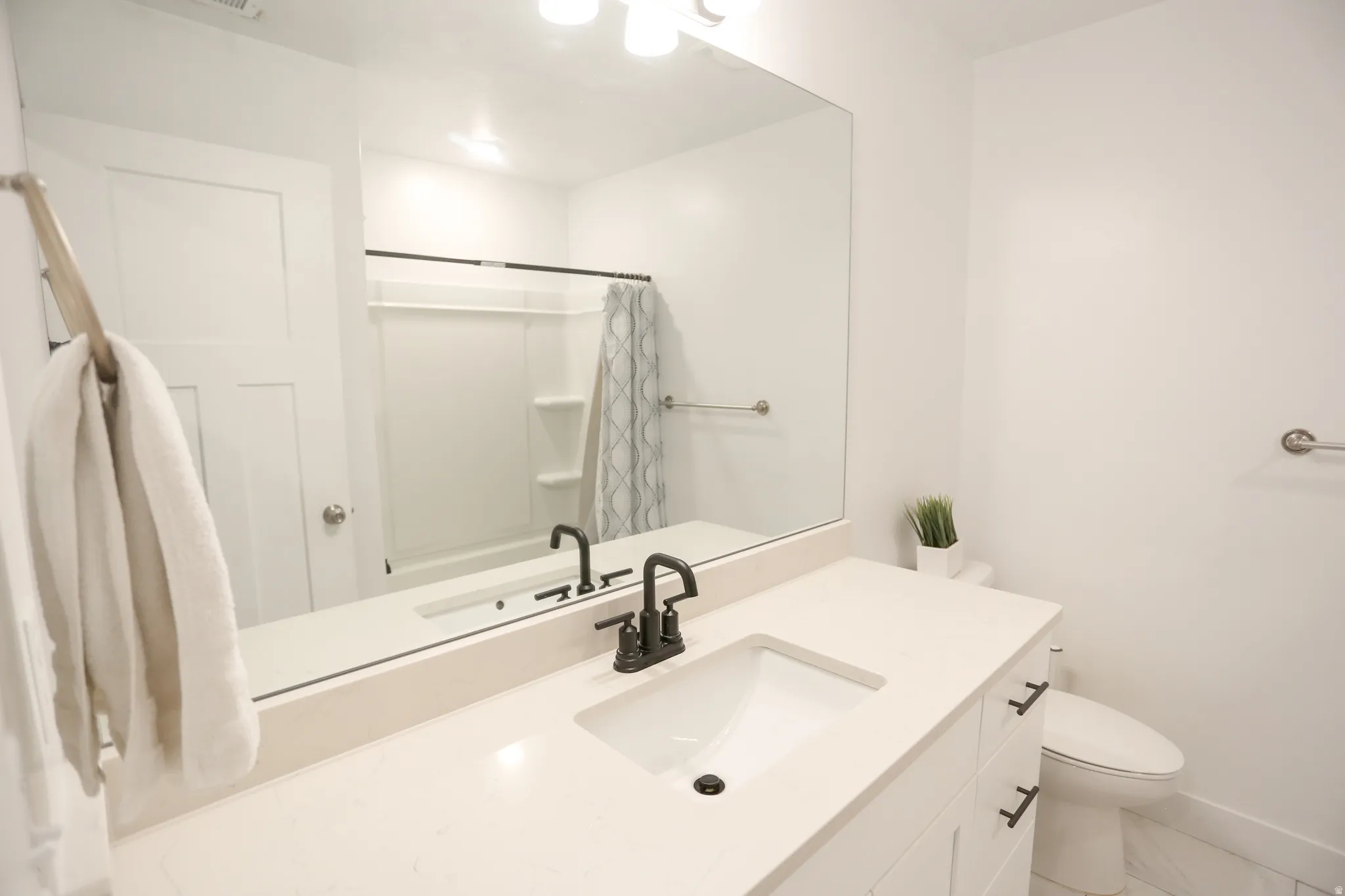 Bathroom with vanity and curtained shower