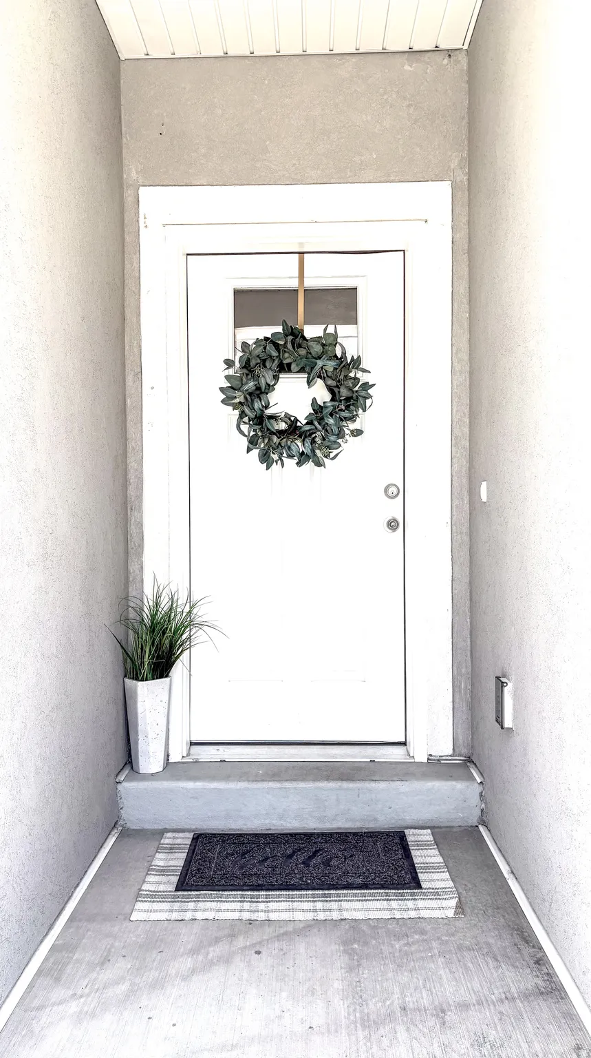 Entrance to property featuring stucco siding