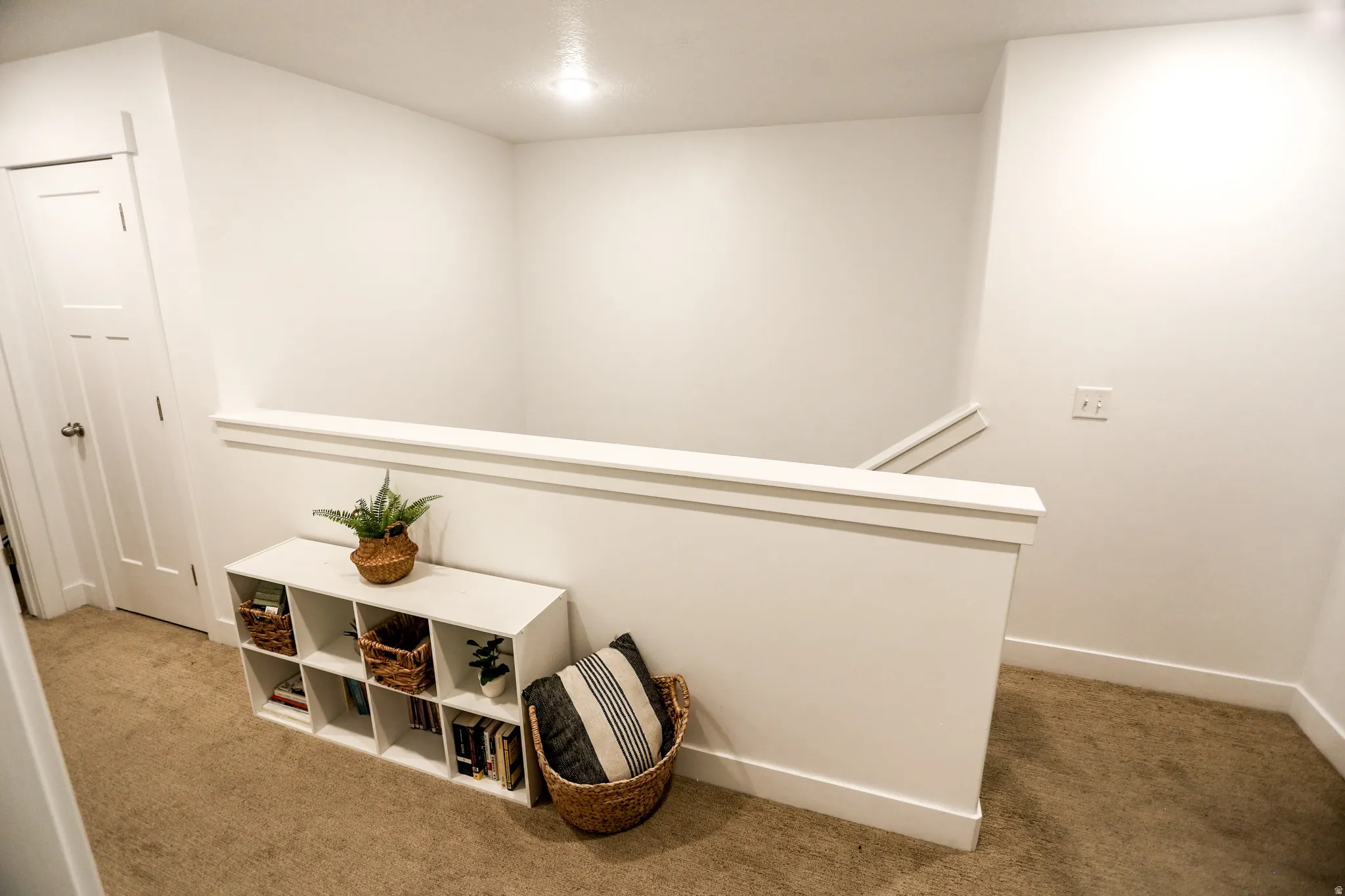 Hall featuring light carpet