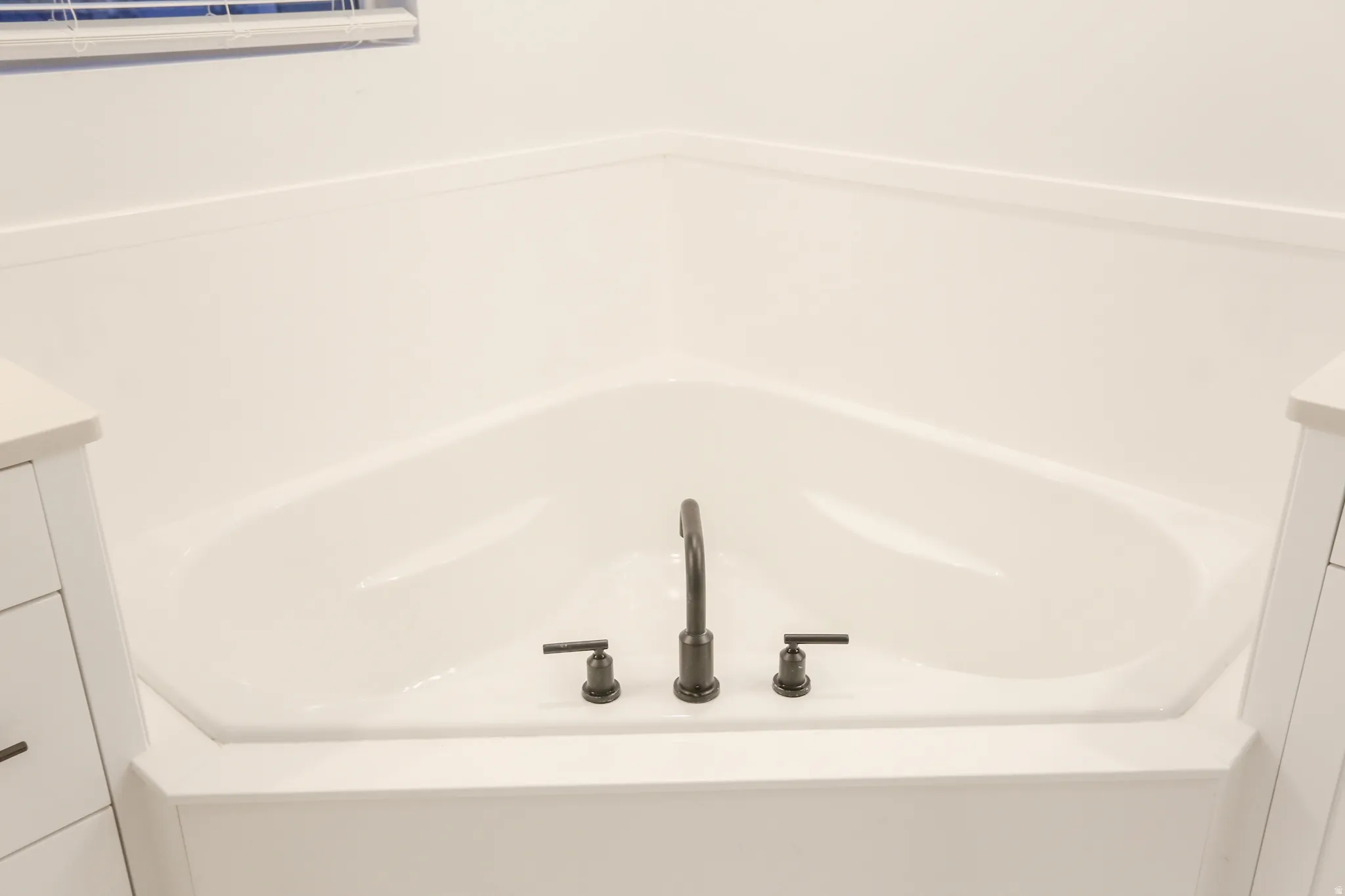 Bathroom view of vanity and a garden tub