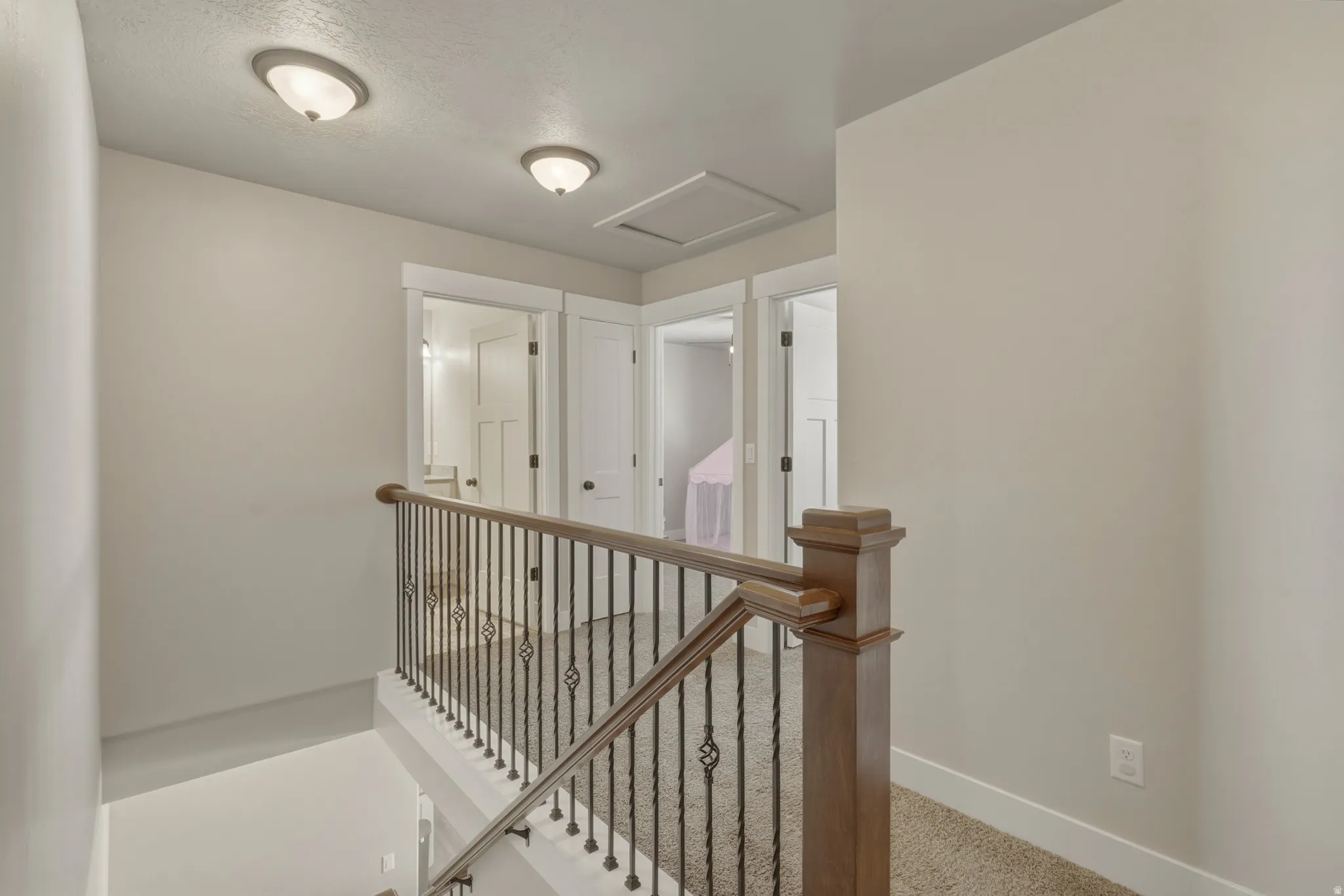 Hallway with an upstairs landing and carpet flooring