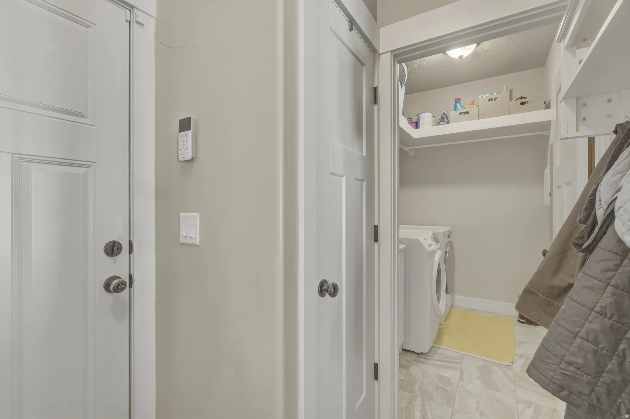 Laundry area featuring washer and clothes dryer and baseboards