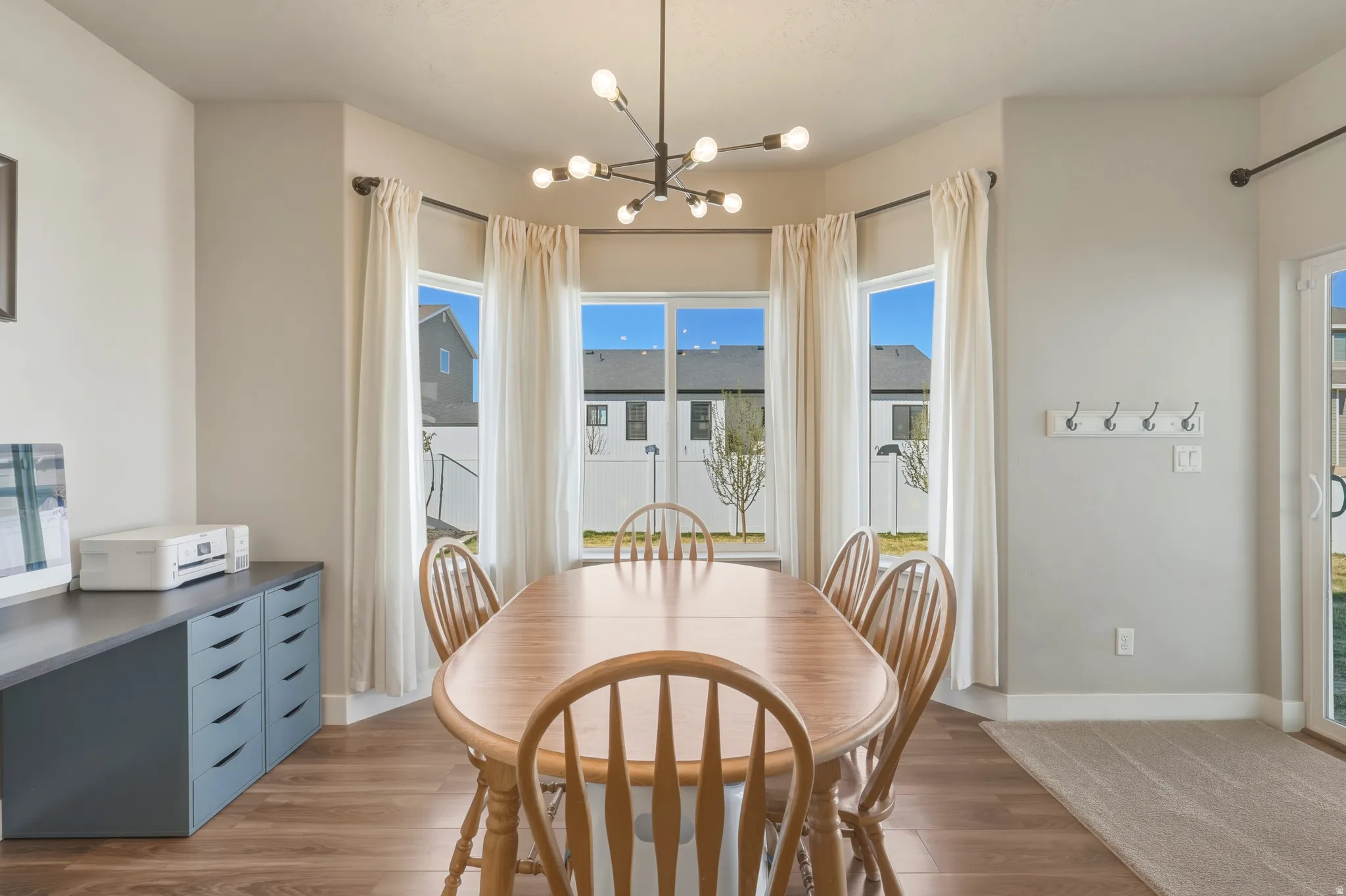 Dining space featuring suspended lighting and wood finished floors