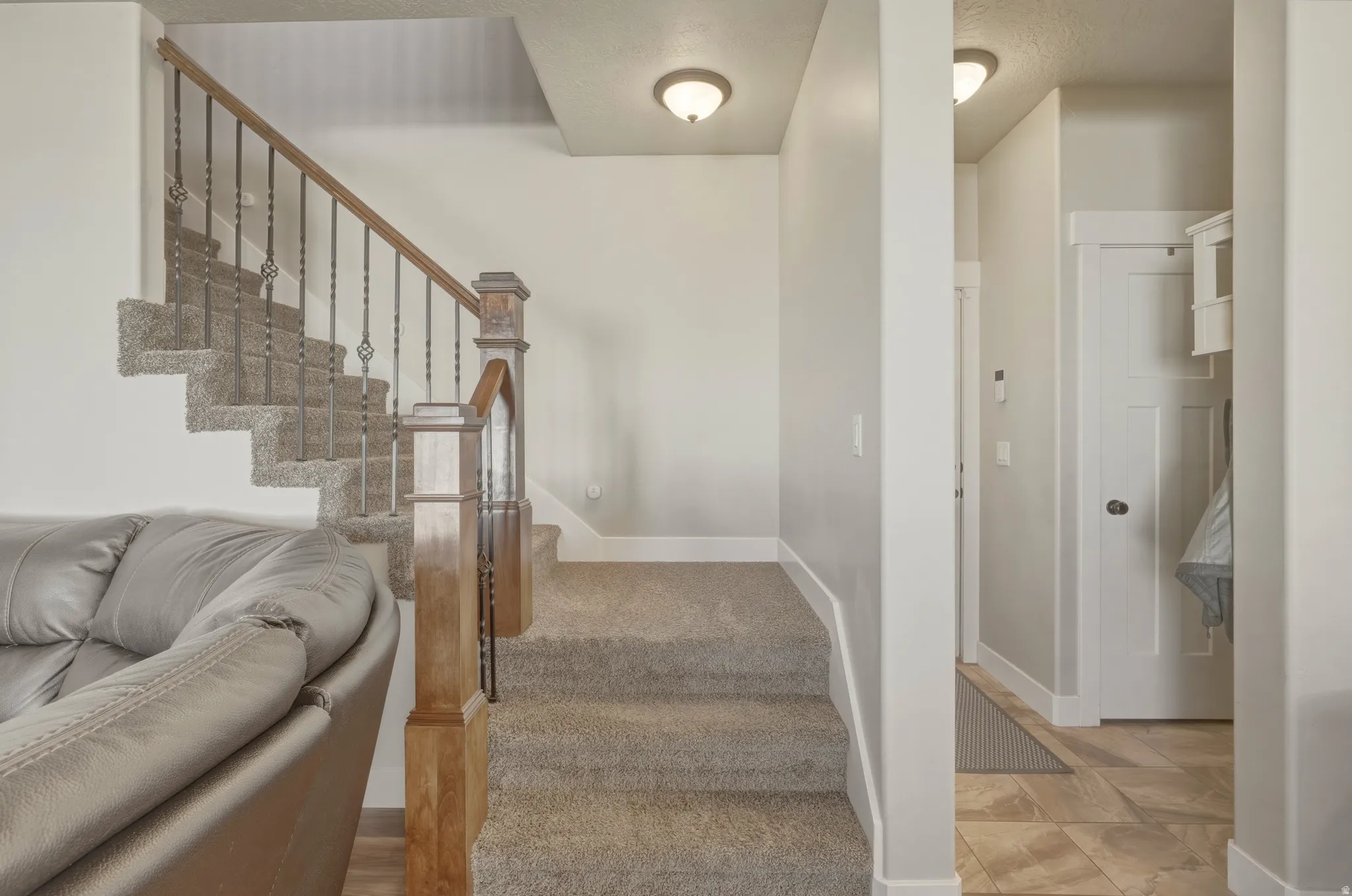 Stairs with baseboards and carpet flooring