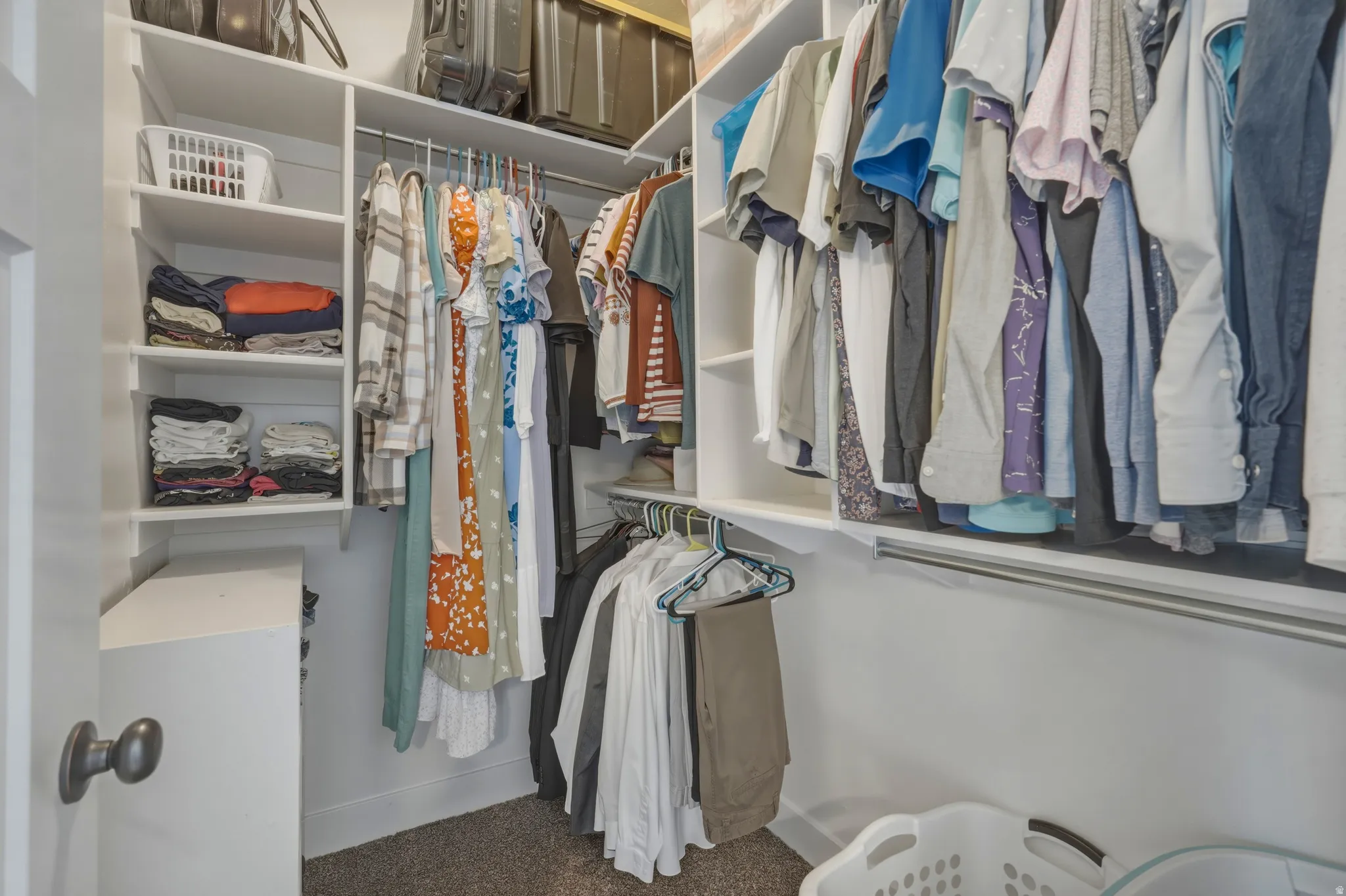 Walk in closet featuring dark carpet
