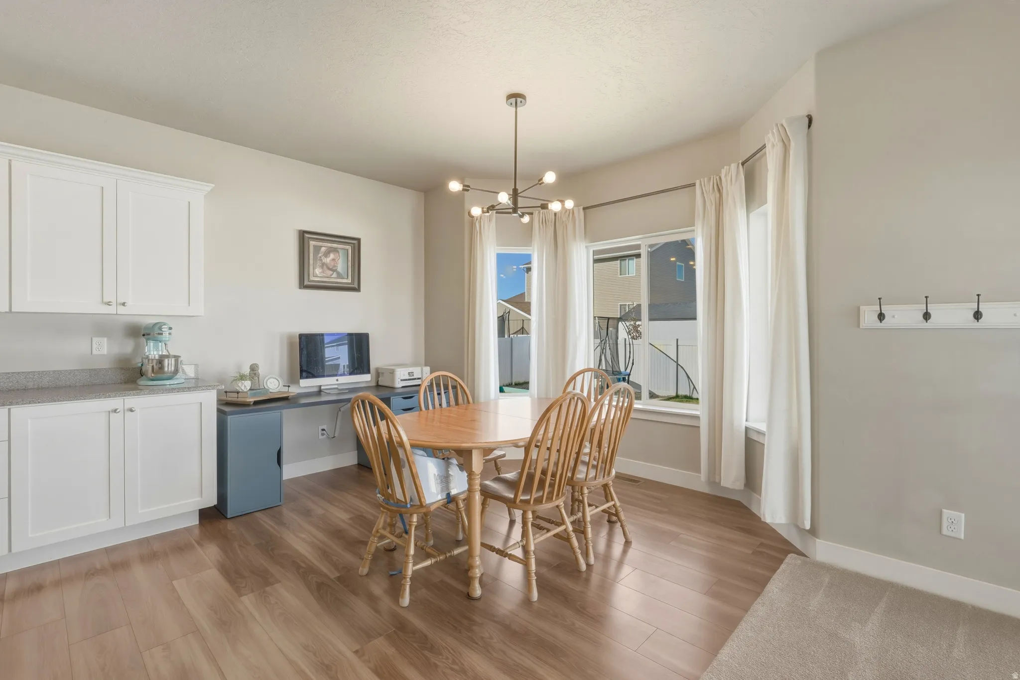 Dining space featuring light wood-style flooring and a chandelier