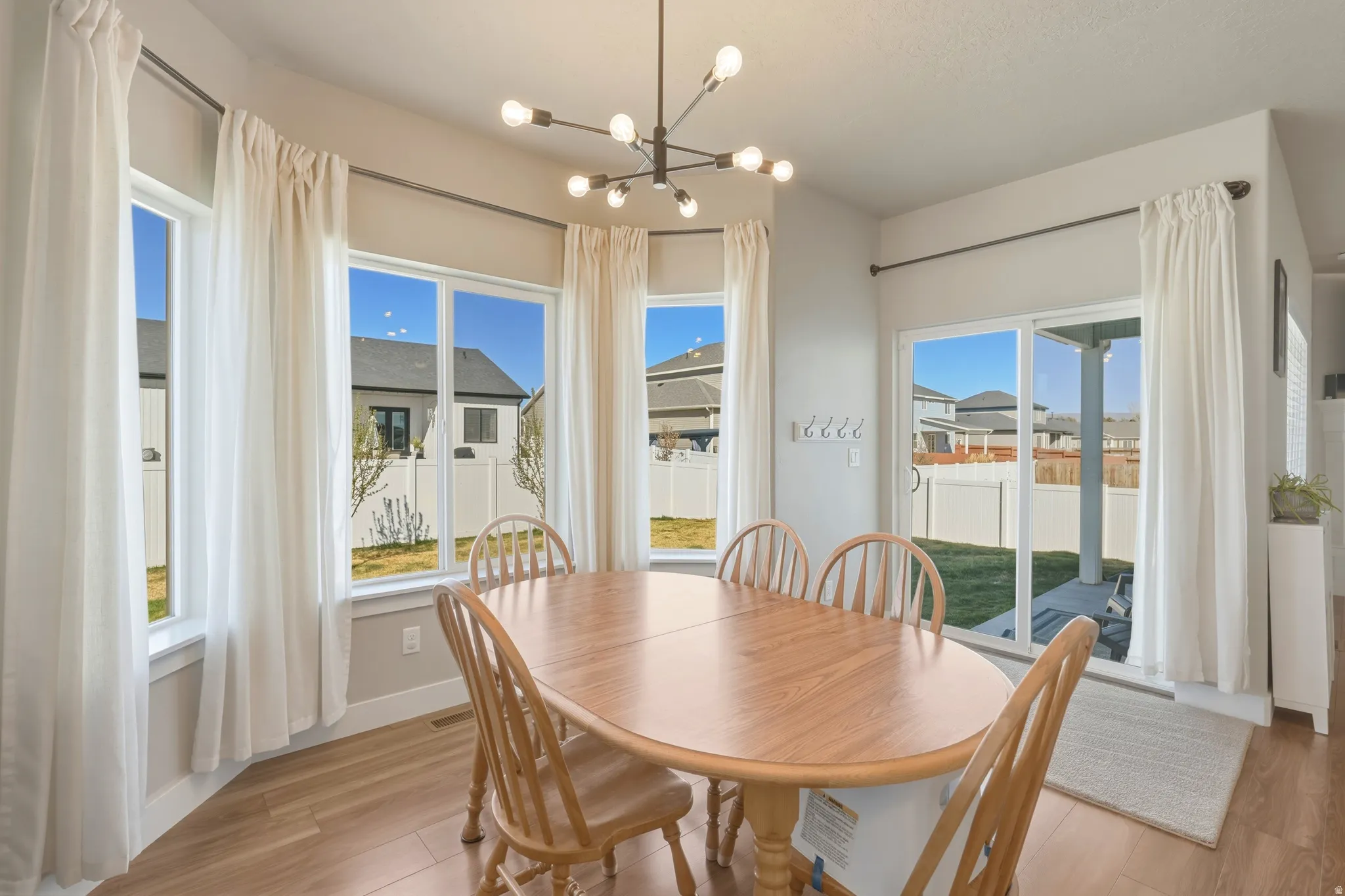 Dining area with hanging lights and light wood-style floors