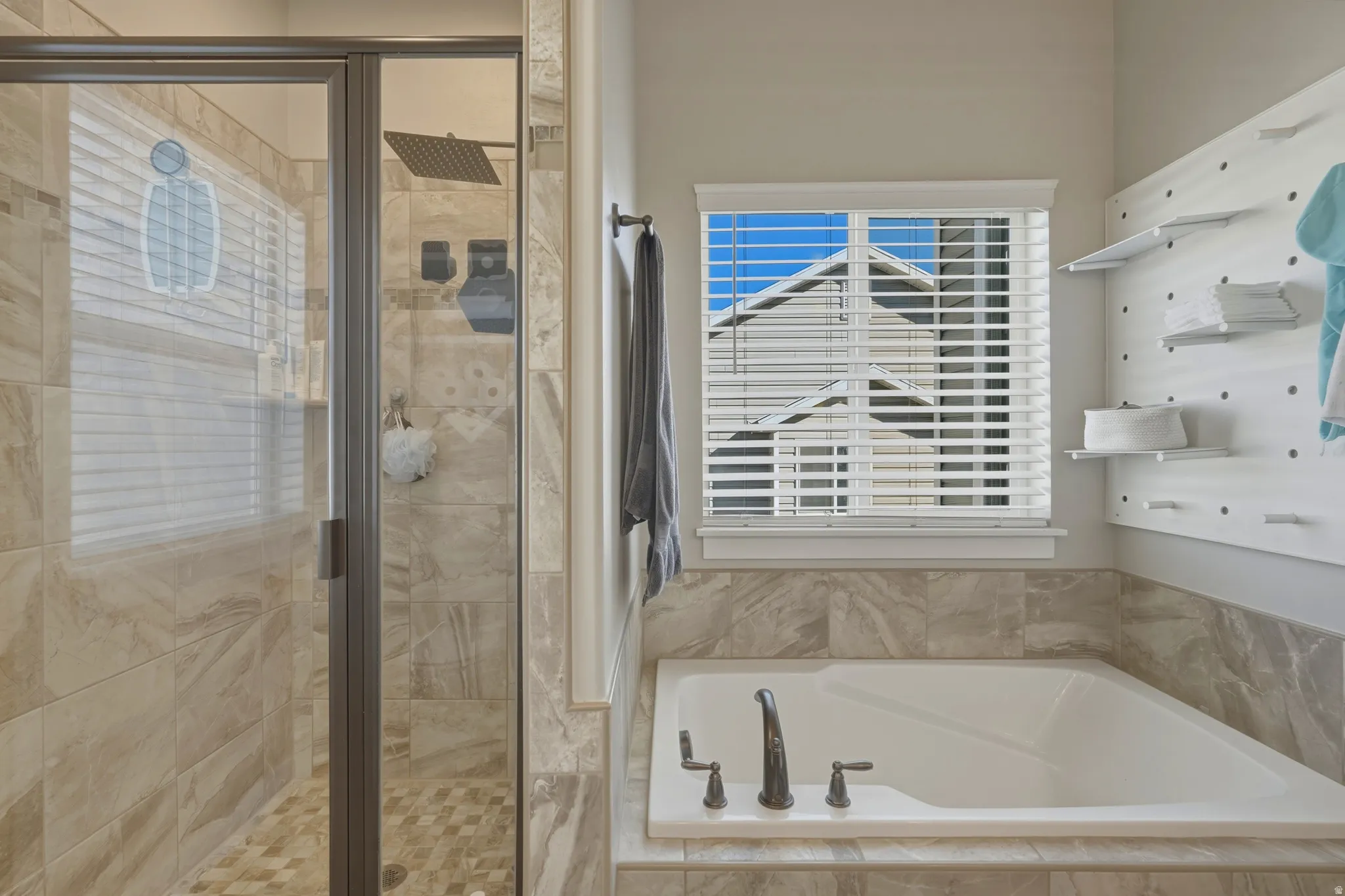 Bathroom with a stall shower and a bath