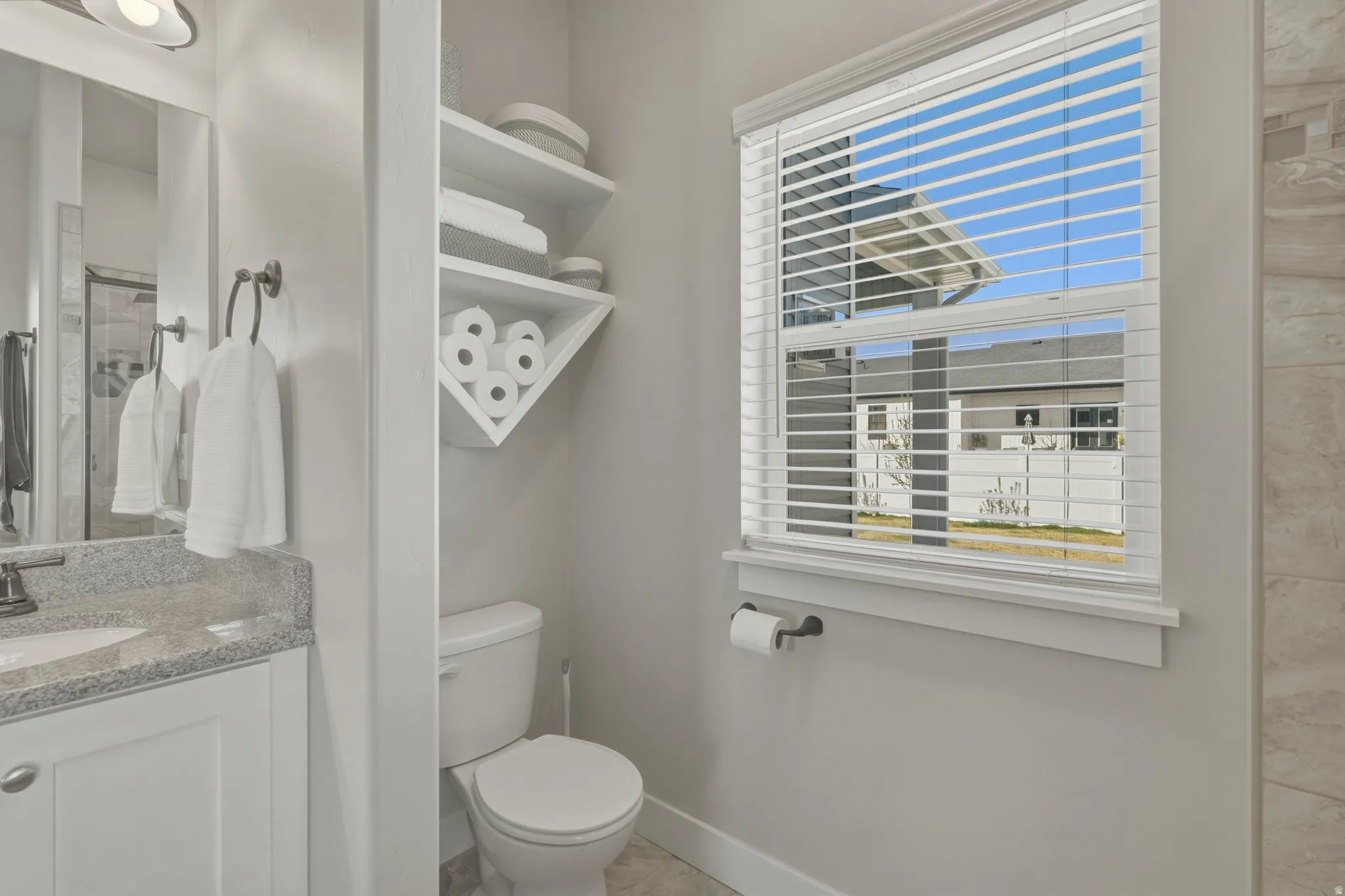 Full bath with a shower stall and vanity