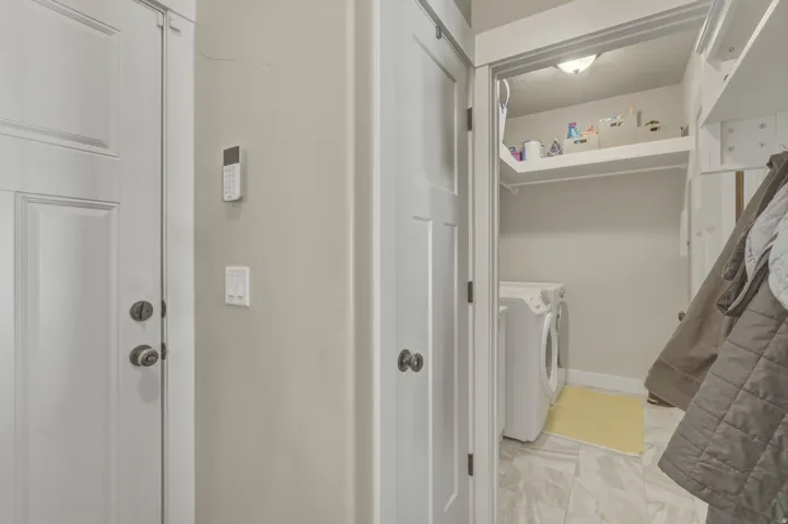 Laundry area featuring washer and clothes dryer and baseboards