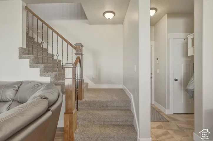 Stairs with baseboards and carpet flooring