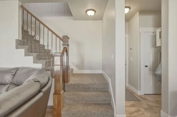 Stairs with baseboards and carpet flooring