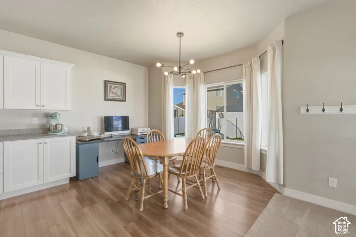 Dining space featuring light wood-style flooring and a chandelier
